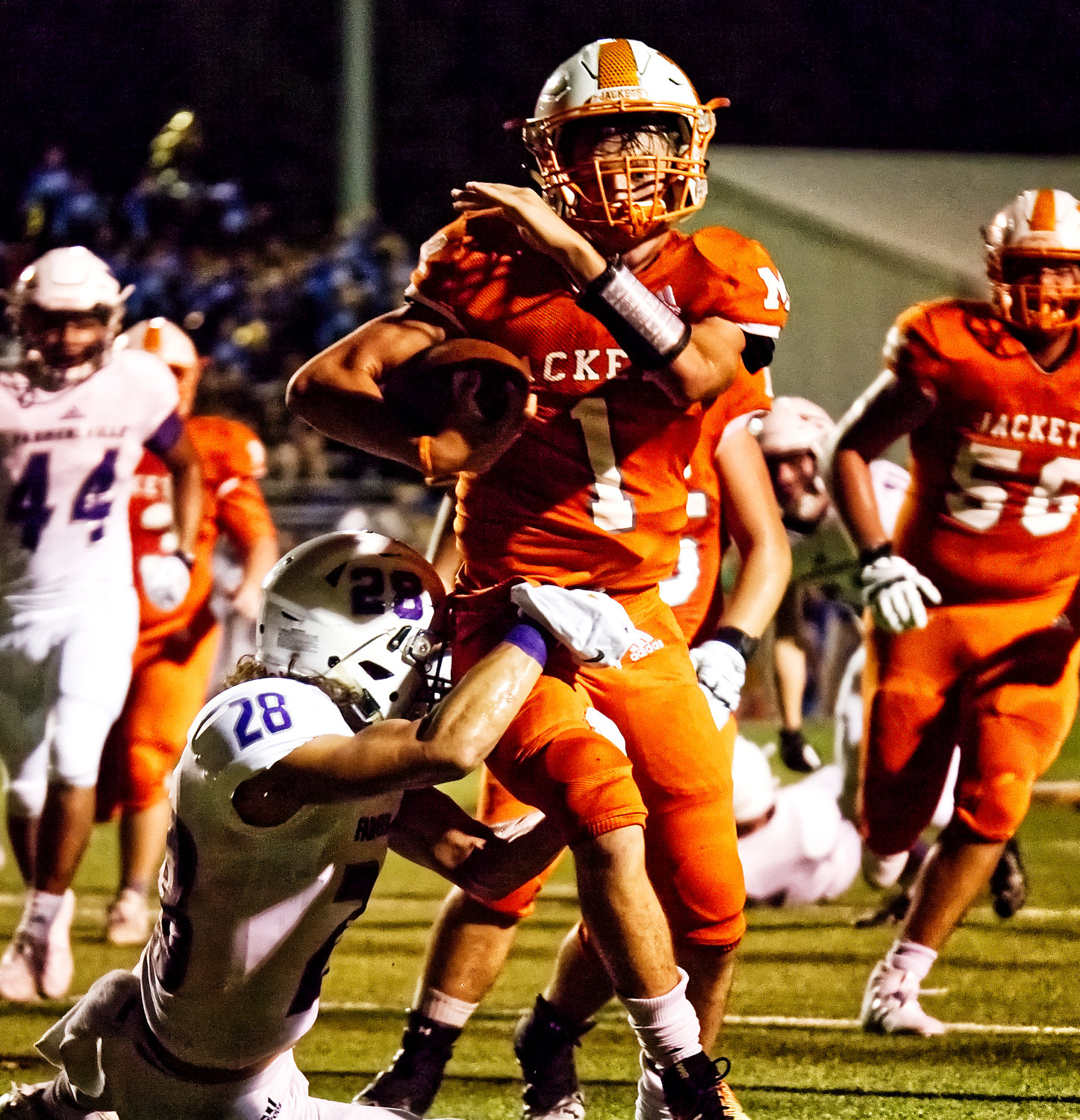 Quarterback Thomas Hooten carries the ball, pushing the Yellowjackets deep into the red zone.